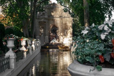 Paris, France - August 12, 2022: The Medici Fountain is a fountain in the Luxembourg Gardens in Paris. It was built around 1630 by Marie de Medici, widow of the French King Henry IV.