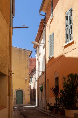Hyres, France - August 10, 2022: Narrow street with yellow houses. Mediterranean style city. Cote d'Azur
