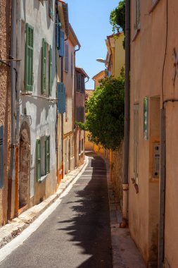 Hyres, France - August 10, 2022: Narrow street with yellow houses. Mediterranean style city. Cote d'Azur