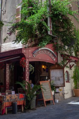 Hyres, France - August 10, 2022: Restaurant with a terrace on the street of the ancient city
