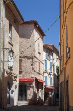 Hyres, France - August 10, 2022: Narrow street with yellow houses. Mediterranean style city. Cote d'Azur