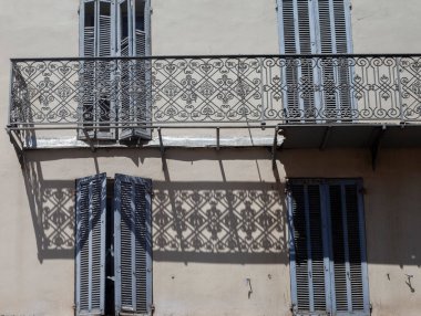 Openwork lattice on the wall of the house with shutters