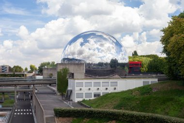 Paris, France - August 24, 2022: Lovelett Parisian park. Glass ball reflecting the blue sky