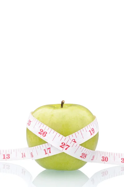 Green apple with measure tape — Stock Photo, Image