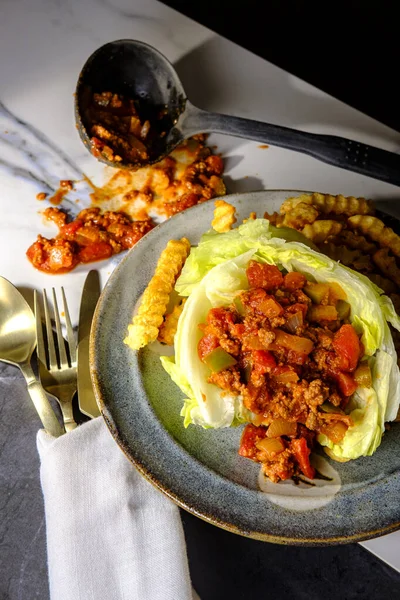 Sloppy Joe lettuce wraps with crinkle cut french fries