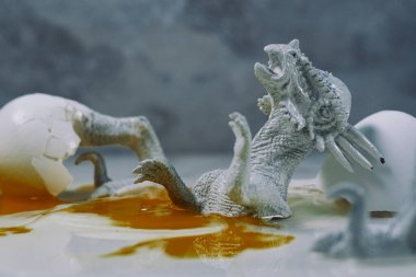 Creepy abstract hatched dead dinosaur egg with yoke concept