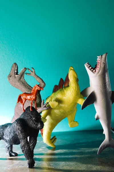 Toy Dinosaurs Shark Bullying Laughing Poor Sad Gorilla — стоковое фото