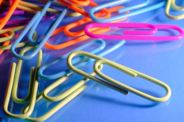 Closeup macro still life of multicolored vivid paperclips