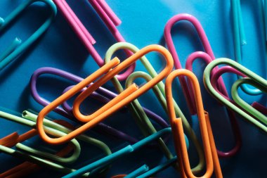 Closeup macro still life of multicolored vivid paperclips