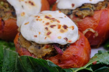 Stuffed tomatoes with mozzarella cheese on display at local deli
