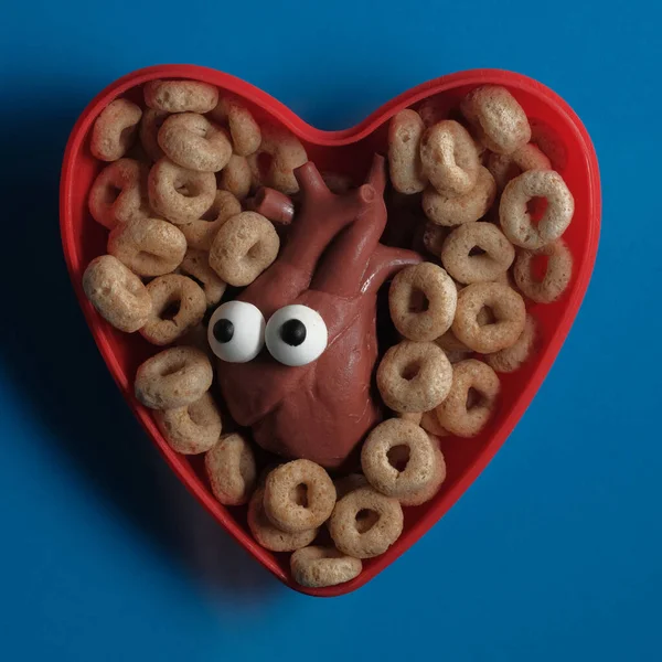 Heart health breakfast cereal concept with anthropomorphic human heart