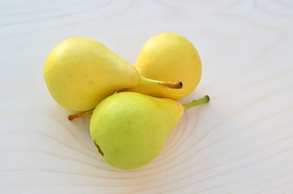 Three pears on wood — Stock Photo, Image
