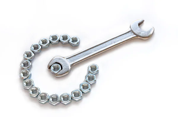 Chrome spanner with nuts and bolts — Stock Photo, Image