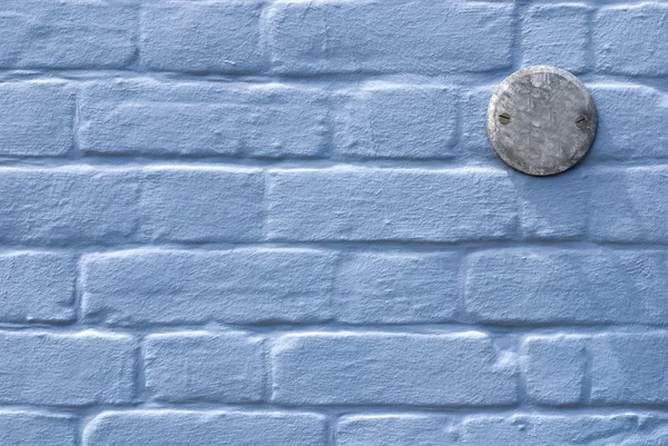 Blauwe muur met kenteken — Stockfoto