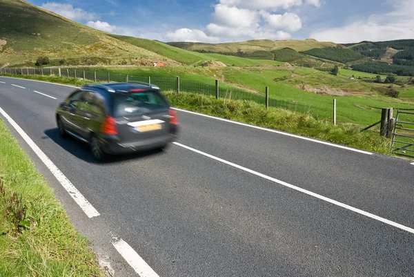 Car speeding on the mountain road in Wales — Stock Photo, Image