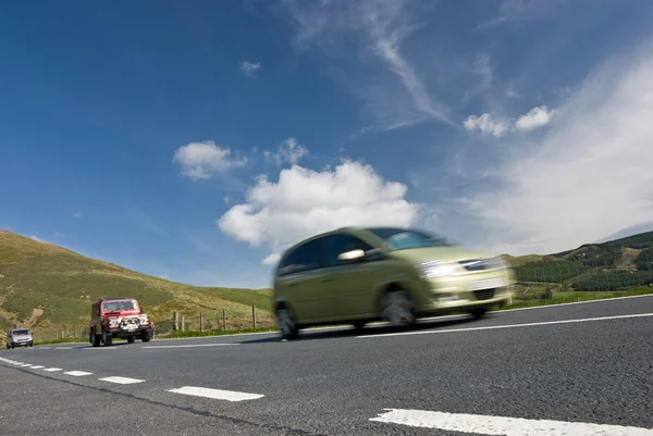 Speeding cars on mountain road — Stock Photo, Image