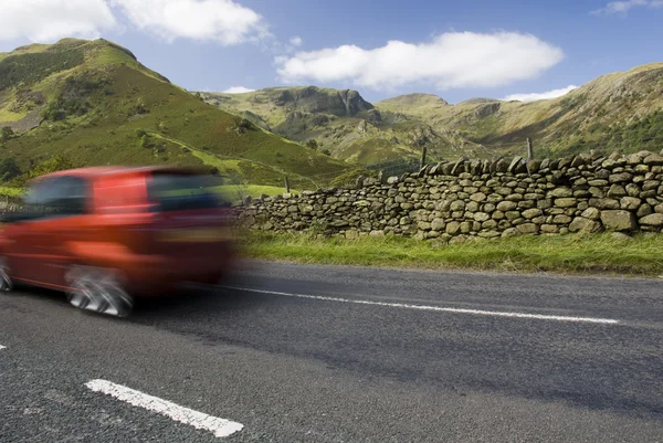 Speeding red car, Lake District, UK 2 — Stock Photo, Image