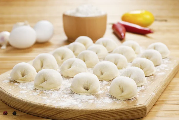 Meat dumplings on the kitchen board — Stock Photo, Image