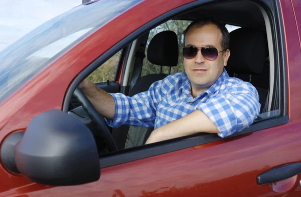 Adult man is driving his car — Stock Photo, Image