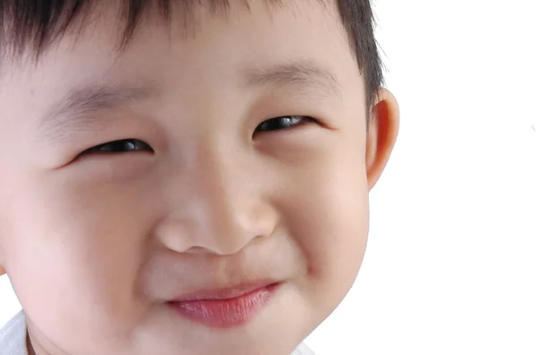 Asiatiska kid leende med vit bakgrund Stockbild