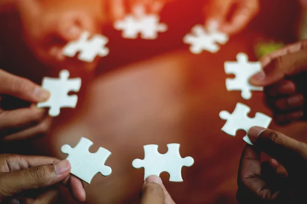 teamwork white business and puzzle of cooperation unity concept jigsaw puzzle close-up hand of hand connected jigsaw puzzle connected to each other business solution Success Concepts and Strategies