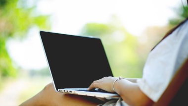 online communication woman using laptop web surfing and online world work at home yellow background communication concept