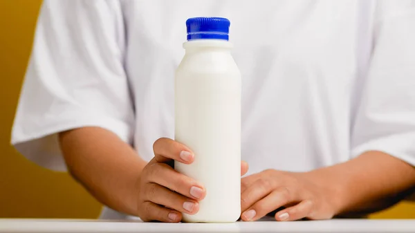 Hands and bottles. Get ready to drink milk, drink healthy milk, fresh milk from the milk frother.