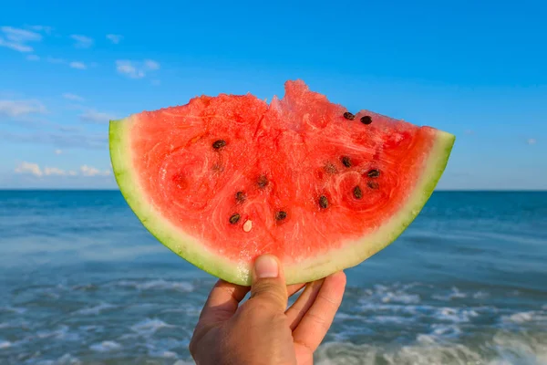 Ripe Watermelon Piece Hand Sea Sky Background — Stock Photo, Image