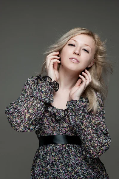 Young blond female gently looking with blowing hair — Stock Photo, Image