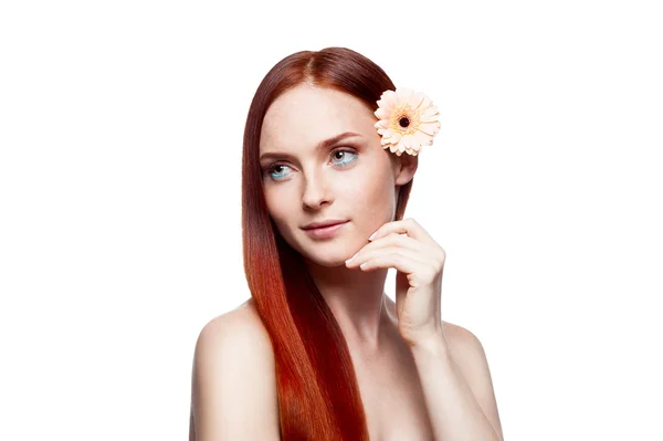 Young red-haired female with gerbrera flower in hair — Stock Photo, Image