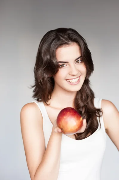 Young casual caucasian girl with red apple — Stock Photo, Image