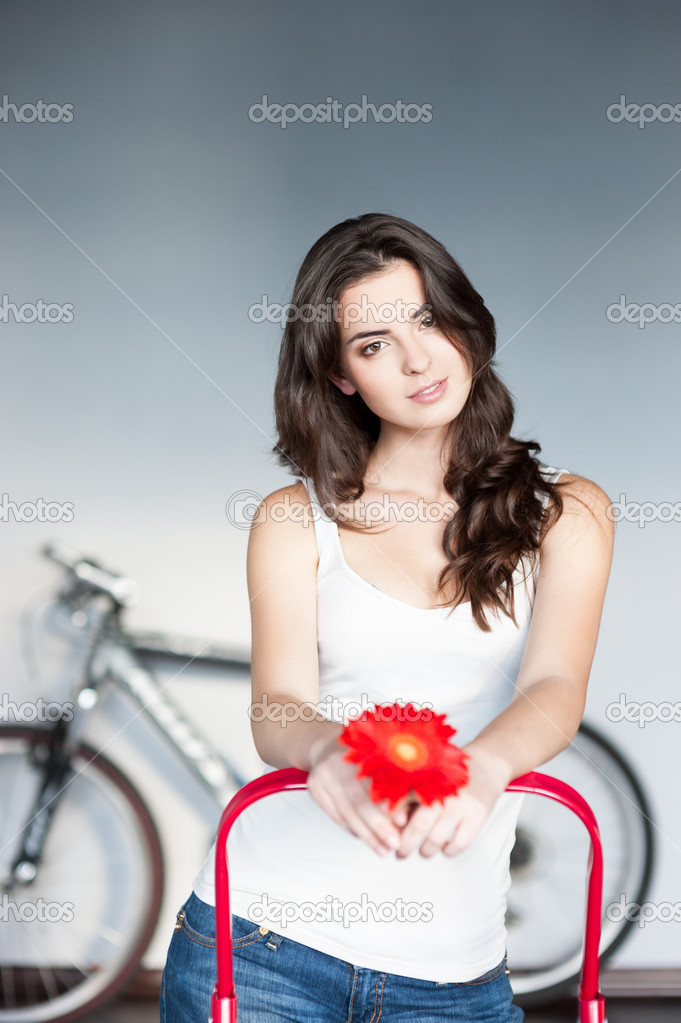 Young casual caucasian girl with red flower