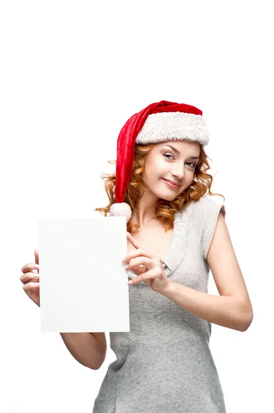 Young casual girl in santa hat holding sign — Stock Photo, Image