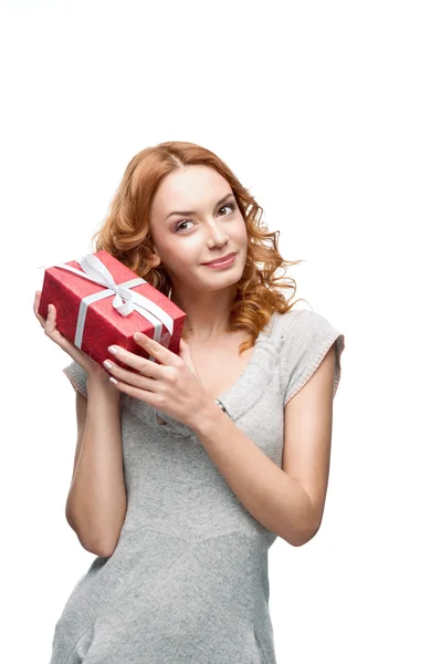 Young thoughtful happy smiling girl holding gift — Stock Photo, Image