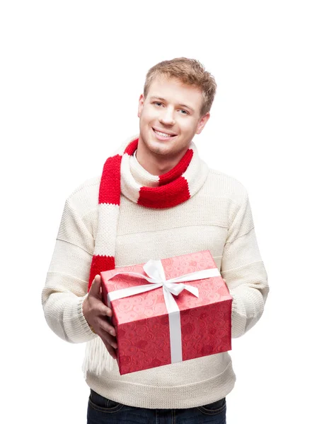Young man holding red christmas gift — Stock Photo, Image