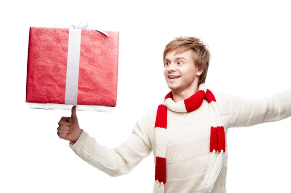 Young smiling man holding christmas gift — Stock Photo, Image