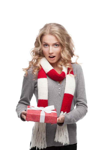 Young surprised woman holding christmas gift — Stock Photo, Image
