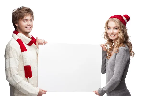 Jovem feliz natal casal segurando grande sinal — Fotografia de Stock