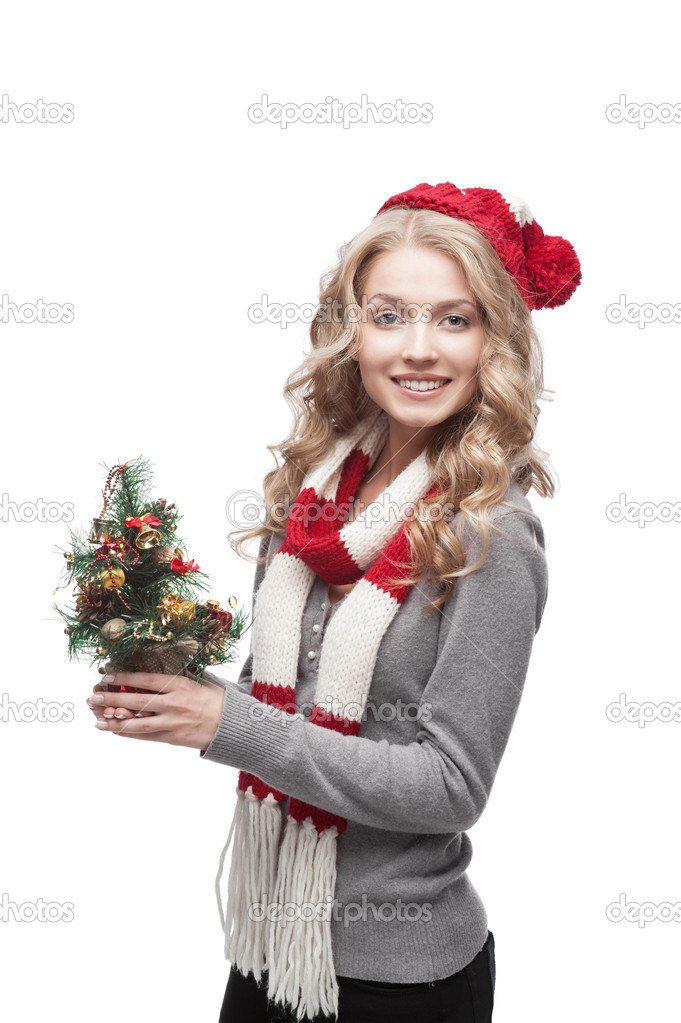 Young smiling woman holding christmas tree