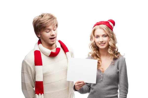 Young happy christmas couple holding sign — Stock Photo, Image