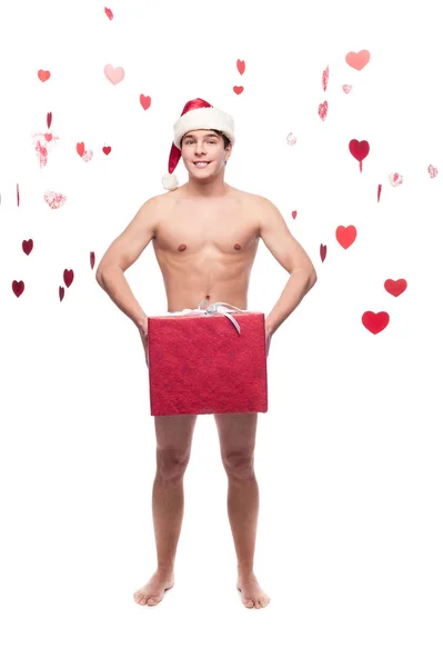 Naked man in santa hat holding christmas gift — Stock Photo, Image