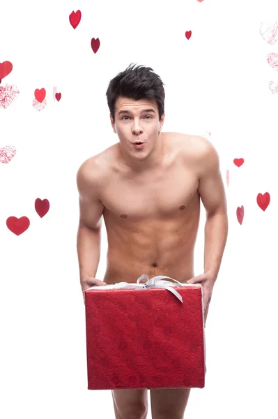 Funny naked man holding christmas gift — Stock Photo, Image