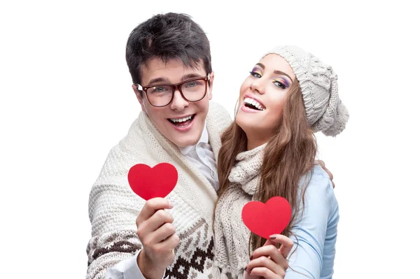 Young cheerful casual couple holding red hearts — Stock Photo, Image