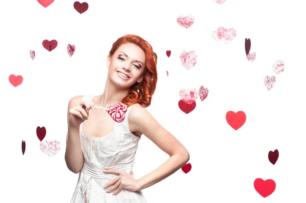 Red-haired woman holding lollipop — Stock Photo, Image