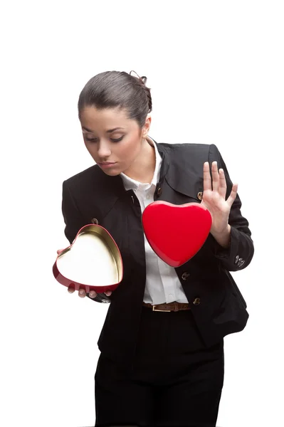Young cheerful businesswoman holding red heart — Stock Photo, Image