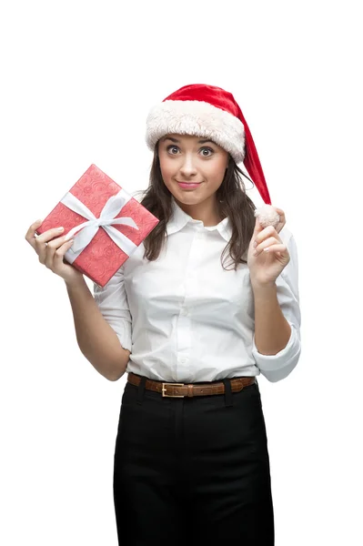 Businesswoman in santa hat holding christmas gift — Stock Photo, Image