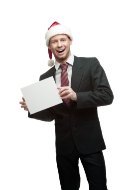 santa şapka işareti tutan işadamı