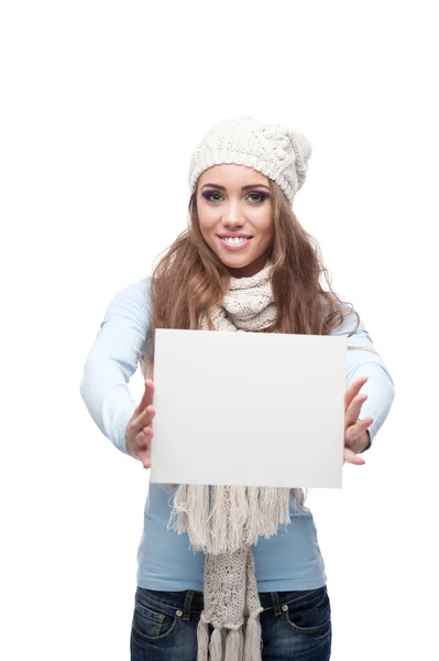 Smiling casual winter girl holding sign — Stock Photo, Image