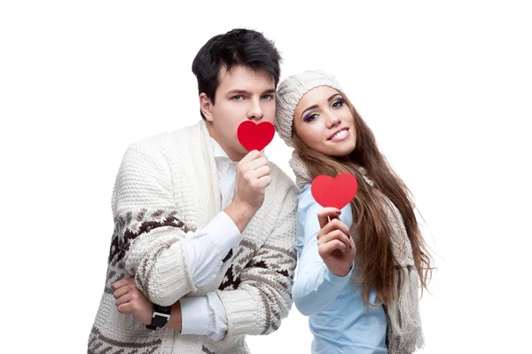 Young cheerful casual couple holding red hearts — Stock Photo, Image