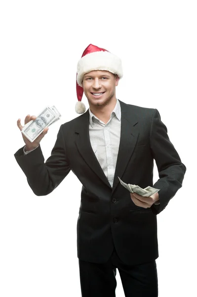 Businessman in santa hat holding money — Stock Photo, Image
